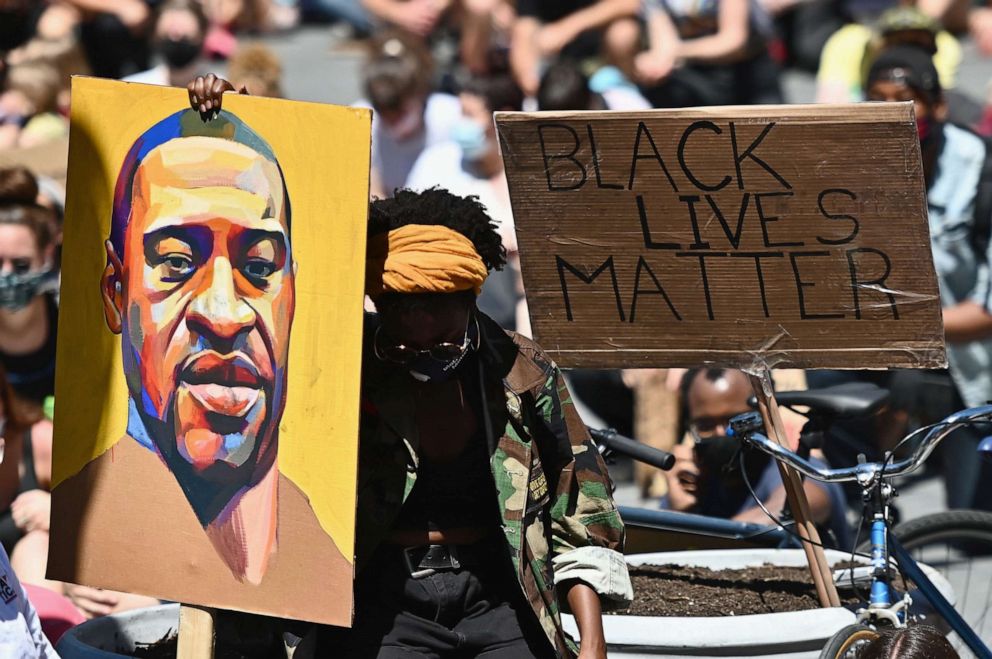 PHOTO: Protesters hold up signs during a "Black Lives Matter" protest in front of Borough Hall, June 8, 2020, in New York City.