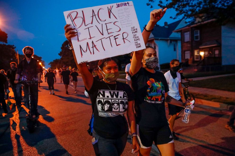 PHOTO: A protester holds a "Black Lives Matter" sign during a demonstration against the police shooting of Jacob Blake in Kenosha, Wisconsin, on Aug. 26, 2020.