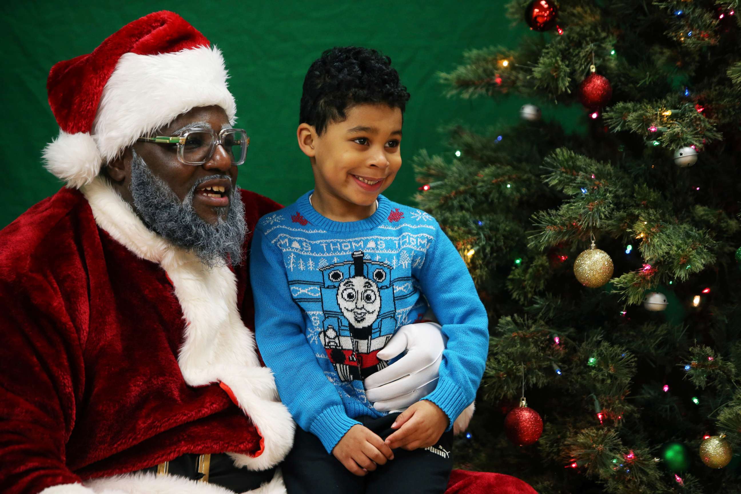 PHOTO: In this Dec. 16, 2018, file photo, a child sits on Santa's lap at the Langston Hughes Performing Arts Institute in Seattle.