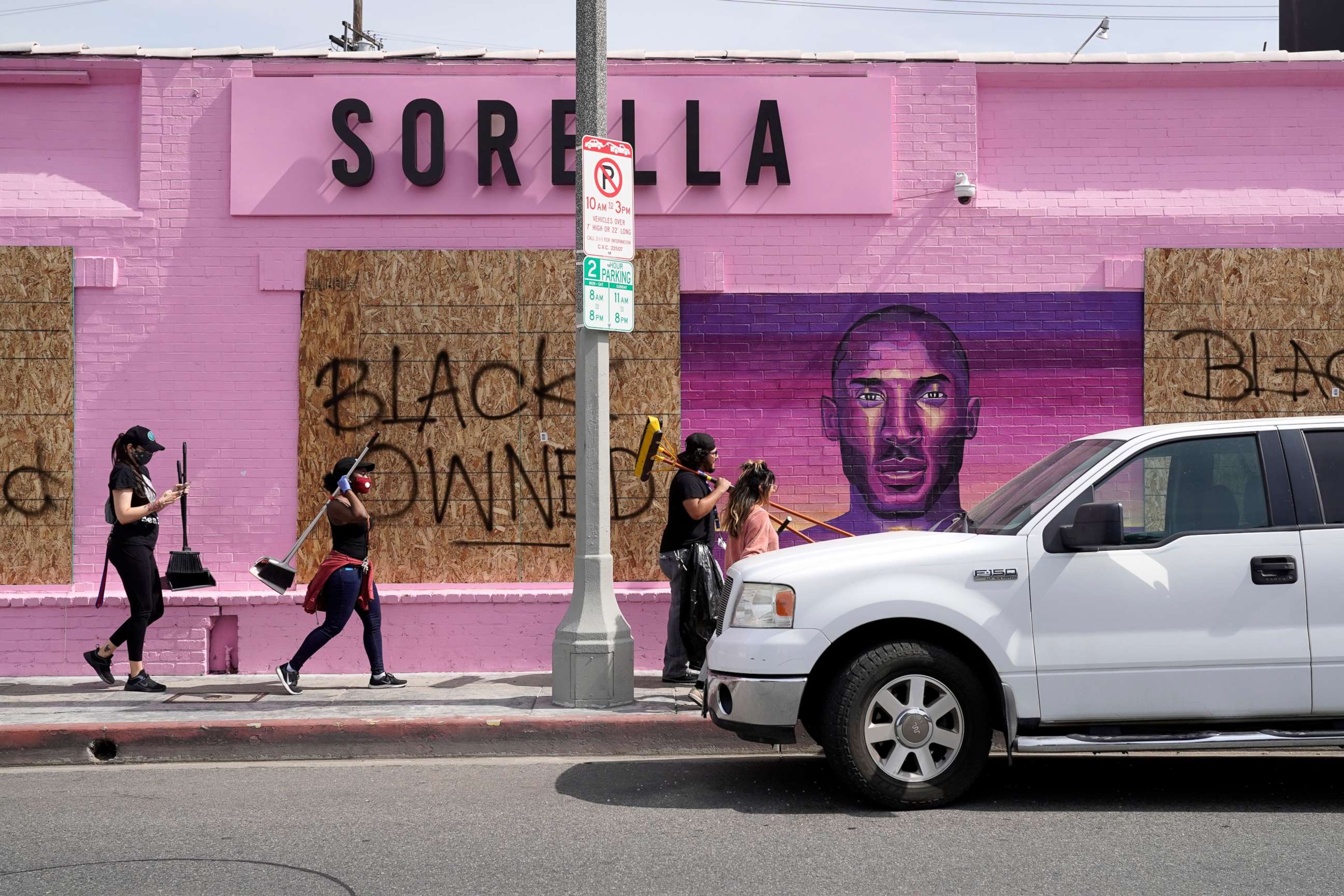 PHOTO: Volunteers walk past a store marked as black owned on May 31, 2020, in Los Angeles.