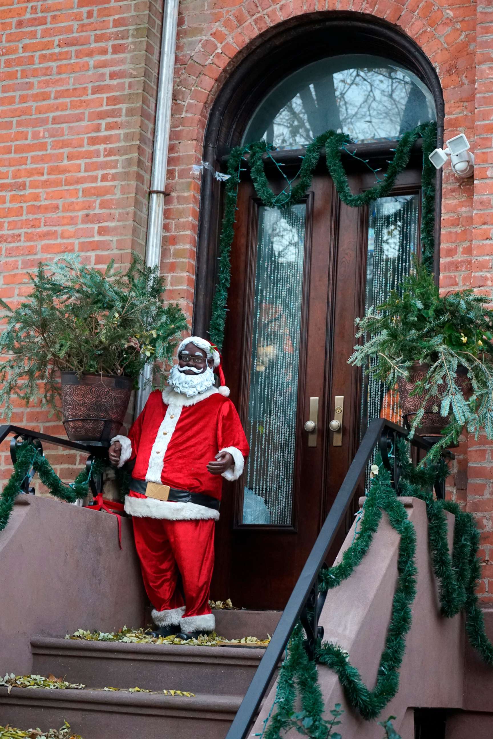PHOTO: In this Dec. 13, 2021, file photo, a Black Santa is seen on a brownstone stoop in the Clinton Hill neighborhood of Brooklyn, N.Y.