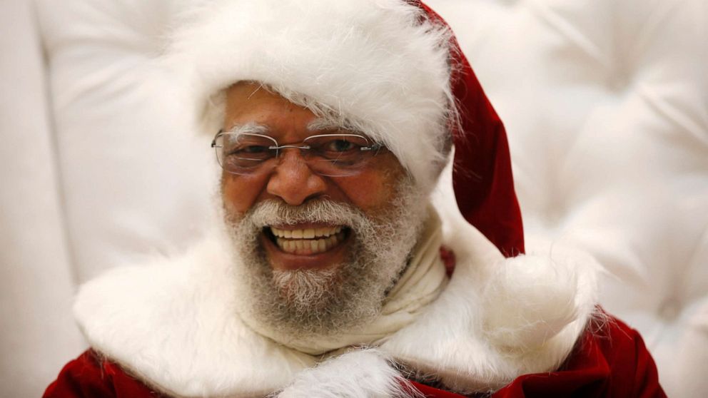 PHOTO: In this Dec. 16, 2013, file photo. Santa Claus Langston Patterson, 77, laughs as he greets children at Baldwin Hills Crenshaw Plaza mall in Los Angeles.