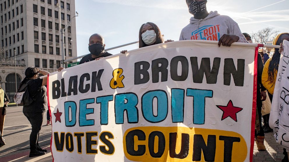 PHOTO: Demonstrators hold a banner that says Black and Brown Votes Count, during a protest in Detroit, Nov. 7, 2020.