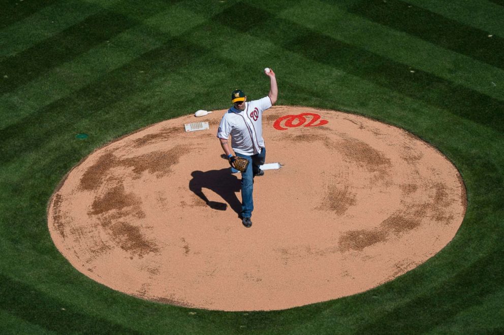 PHOTO: School resource officer Blaine Gaskill throws out the opening pitch of the Washington Nationals' MLB home opener against the New York Mets at Nationals Park in Washington D.C., April 5, 2018.