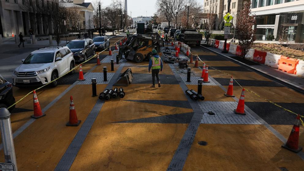 PHOTO: People work to transform Washington, D.C.'s Black Lives Matter Plaza, as part of a new mural project after threats by Congressional Republicans to cut transportation funding if the plaza was not renamed, in Washington, Mar. 10, 2025.