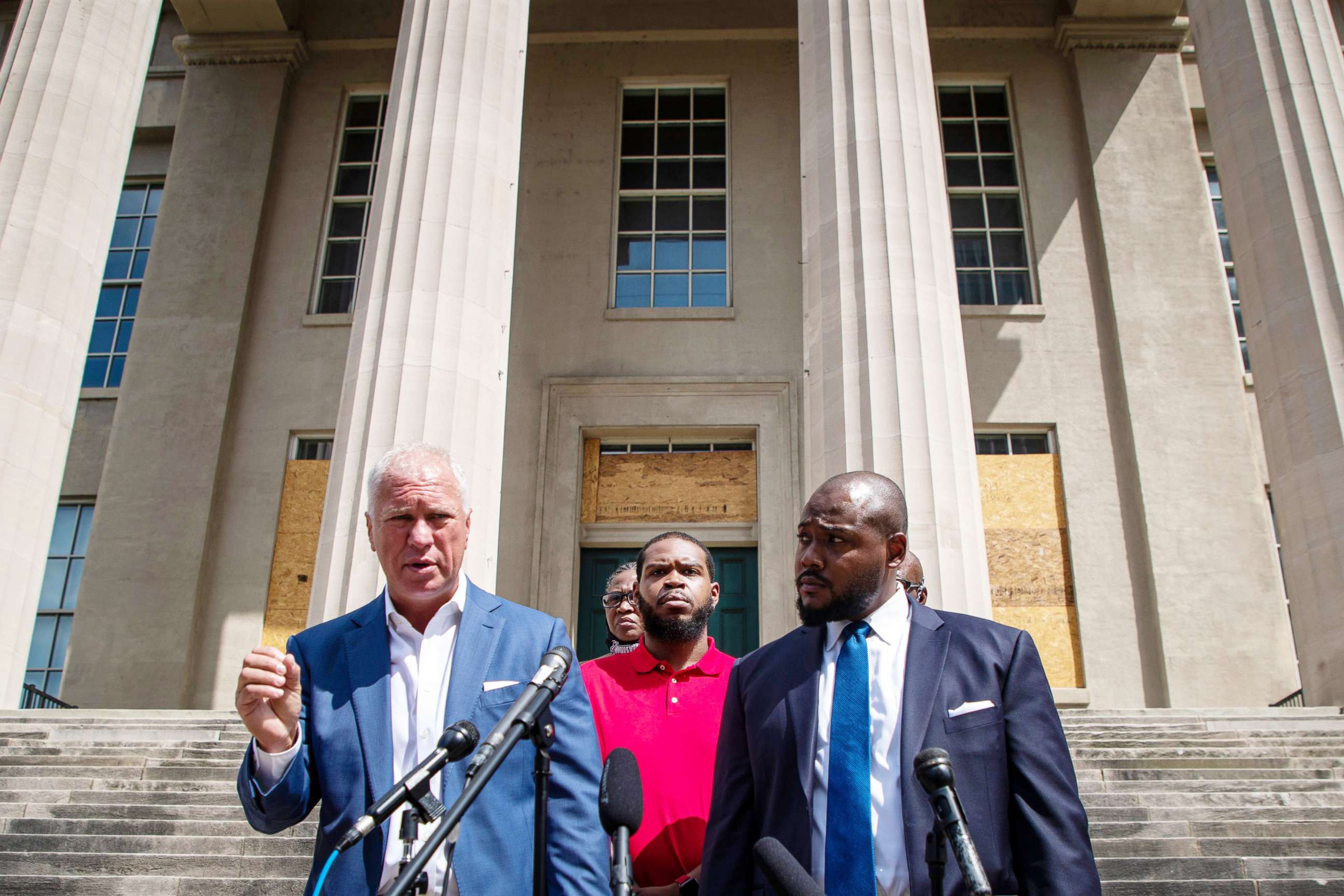 PHOTO: Kenneth Walker, center, the boyfriend of the late Breonna Taylor, stands alongside his mother and attorneys during a press conference in Louisville, Ky., Sept. 1, 2020.