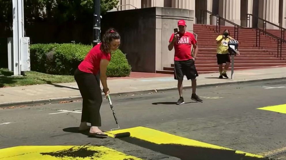 PHOTO: A California couple are seen defacing a Black Lives Matter mural in a video shared by the City of Martinez police seeking community assistance in identifying the couple.