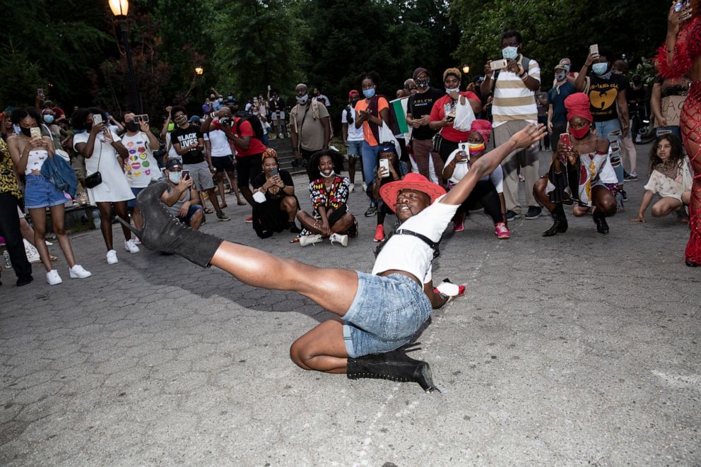 PHOTO: Cotton Juicy Couture performs a stylized dance called 'voguging' for those gathered for the Juneteenth Jubilee at St. Nicholas park in Harlem.