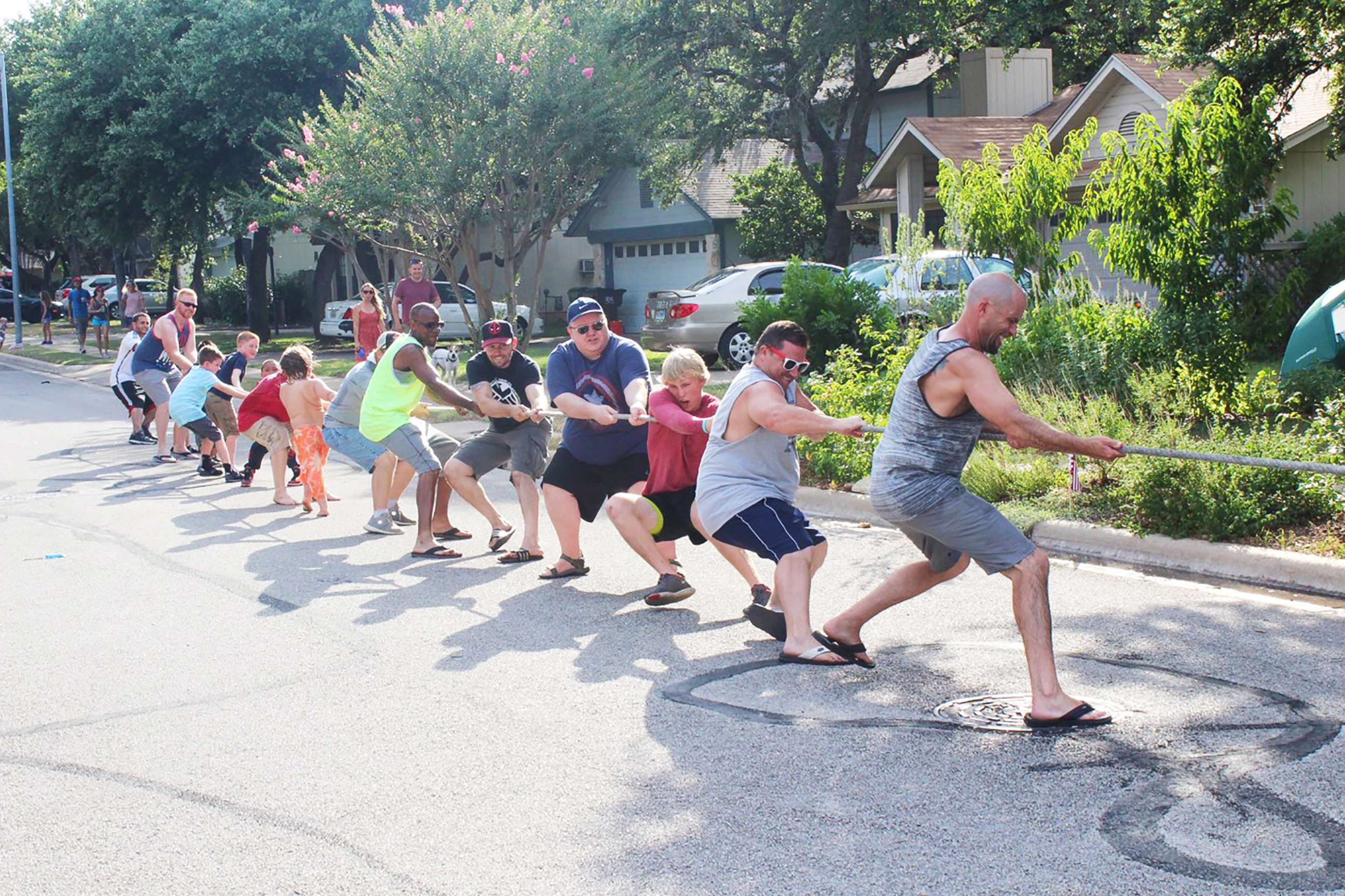 PHOTO: Residents of Riverton Drive in Austin, Texas, participate in a tug of war during one of their annual block parties. 