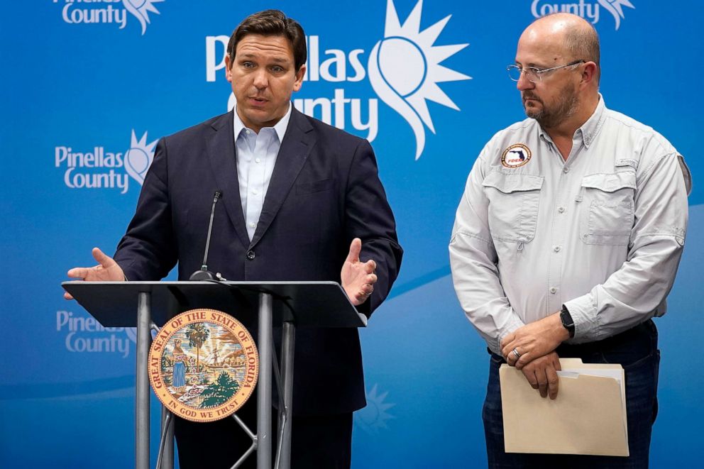 PHOTO: Florida Gov. Ron DeSantis, speaks as he stands with Kevin Guthrie, director of the Florida Division of Emergency Management, during a news conference to keep residents updated on the track of Hurricane Ian in Largo, Fla., Sept. 26, 2022.