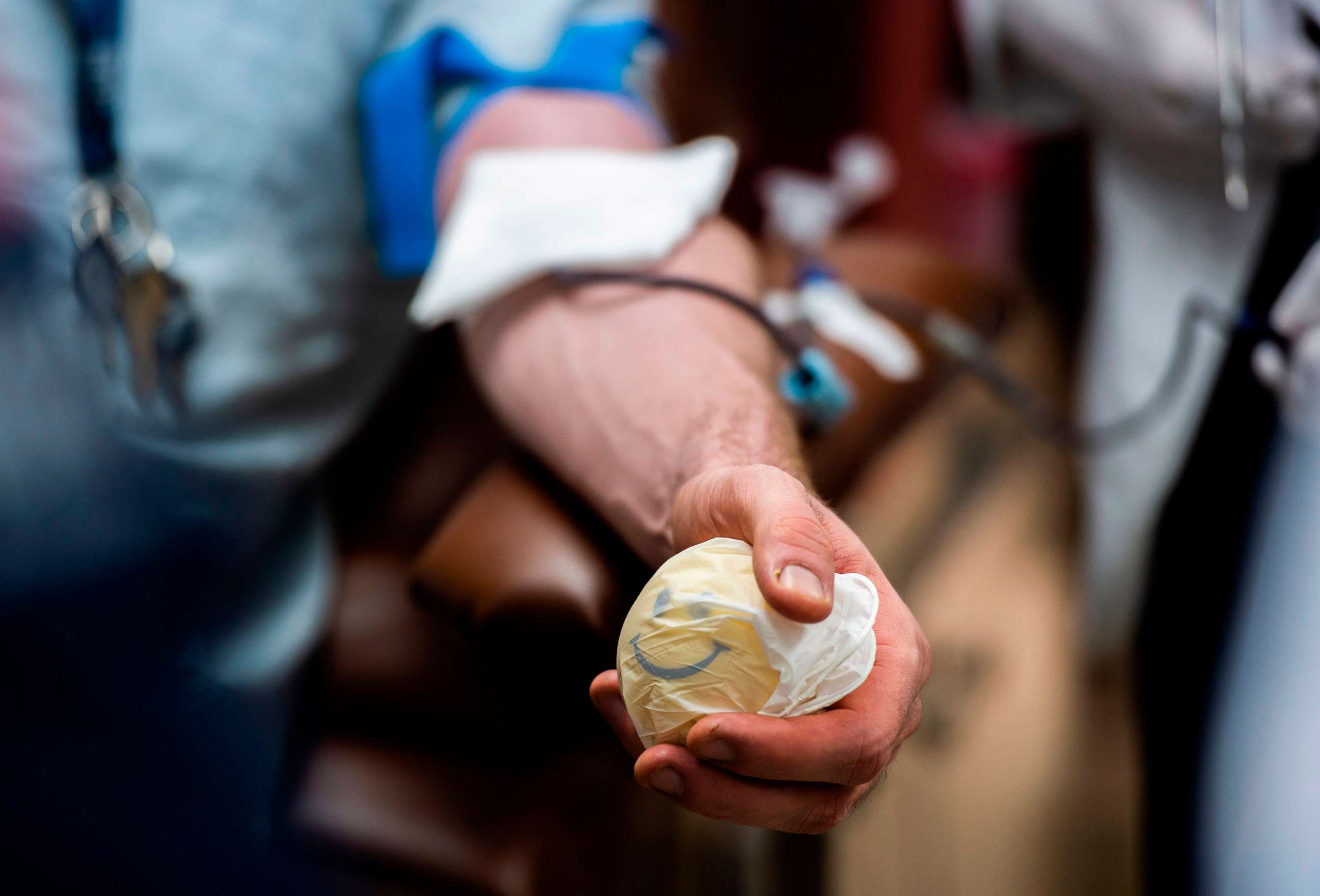 PHOTO: A man squeezes a ball as he donates blood in an INOVA Hospitals Bloodmobile in Washington, D.C., July 21, 2020. This is the first time INOVA has had a mobile blood drive since the rise of COVID-19 cases in the D.C. region. 