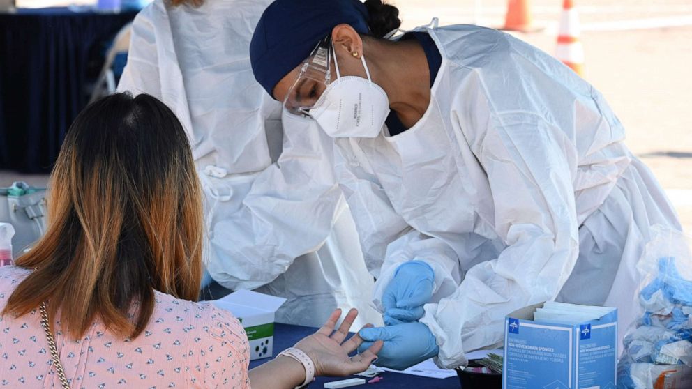 PHOTO: A person undergoes a finger prick blood sample as part of a coronavirus antibody rapid serological test on July 26, 2020 in San Dimas, California, 30 miles east of Los Angeles. 