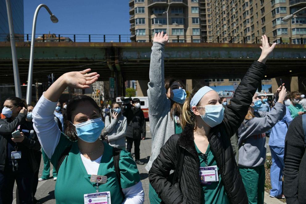 PHOTO: Langone Hospital nurses cheer to  U.S. Air Force Thunderbirds and U.S. Navy Blue Angels honoring frontline COVID-19 responders and essential workers flying over New York City, April 28, 2020. 