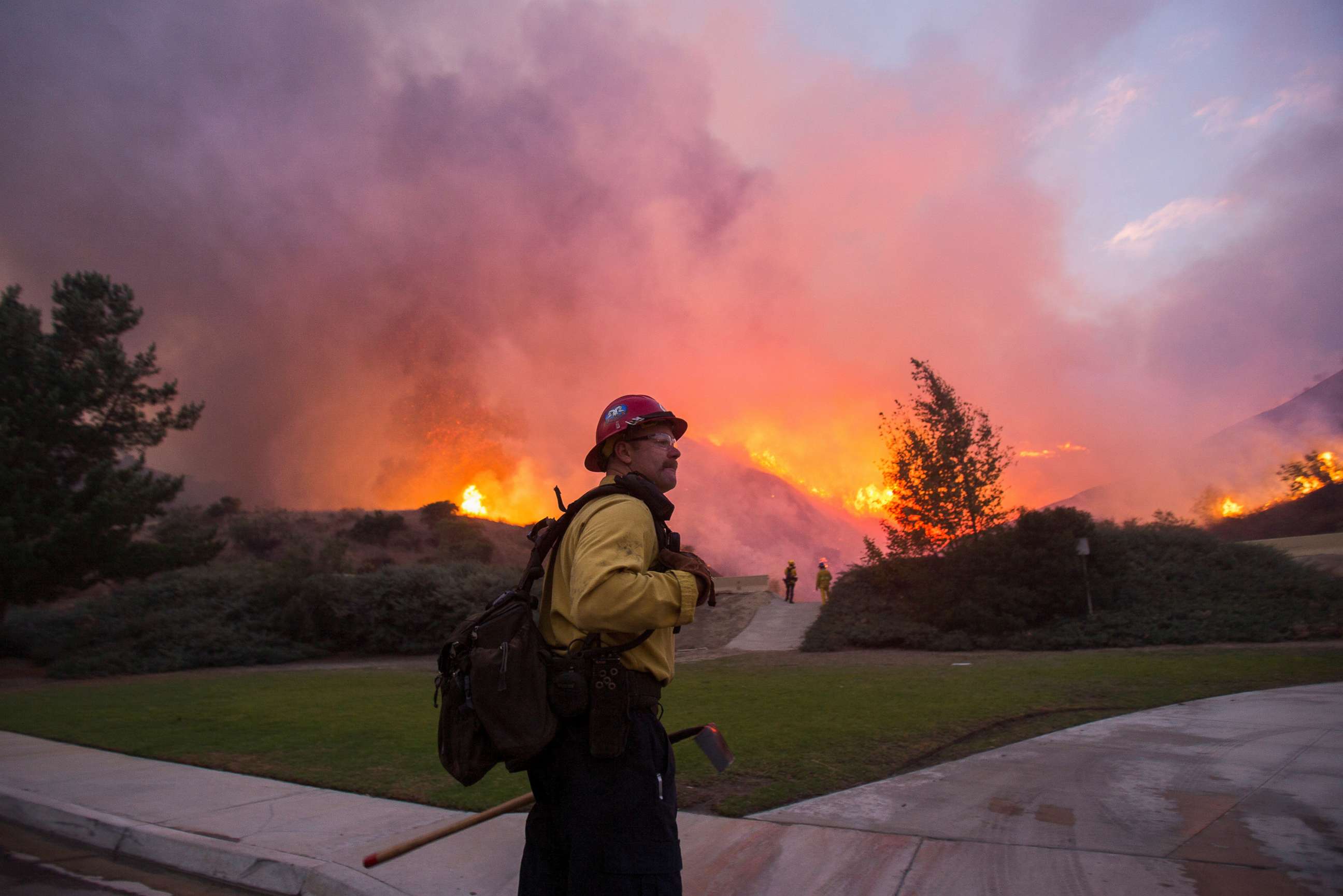 PHOTO: In this Oct. 26, 2020, file photo, a firefighter watches the Blue Ridge Fire burning in Yorba Linda, Calif.