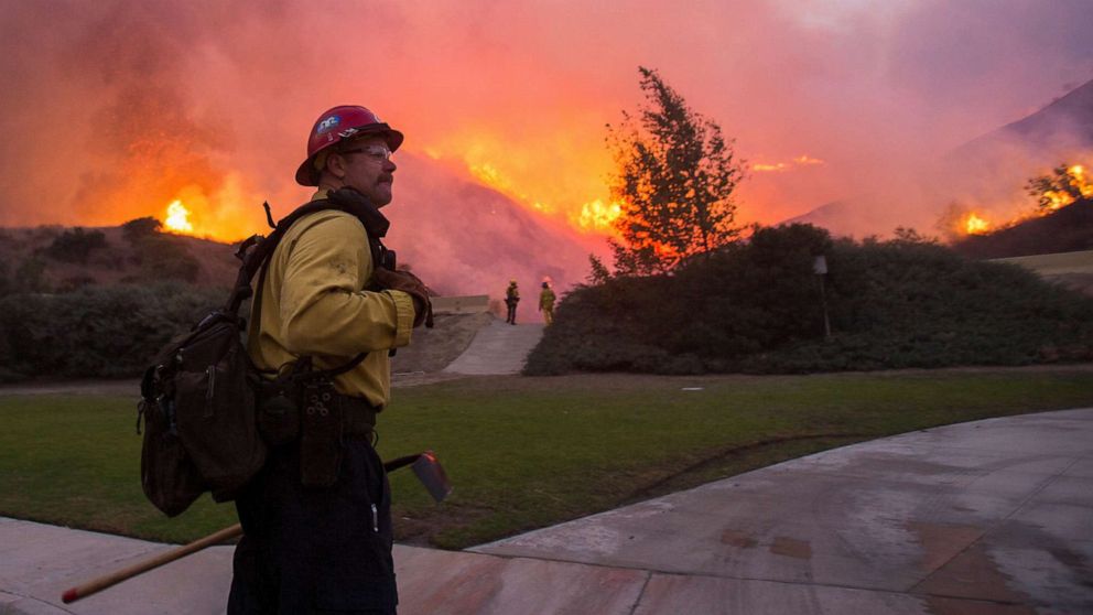 PHOTO: In this Oct. 26, 2020, file photo, a firefighter watches the Blue Ridge Fire burning in Yorba Linda, Calif.