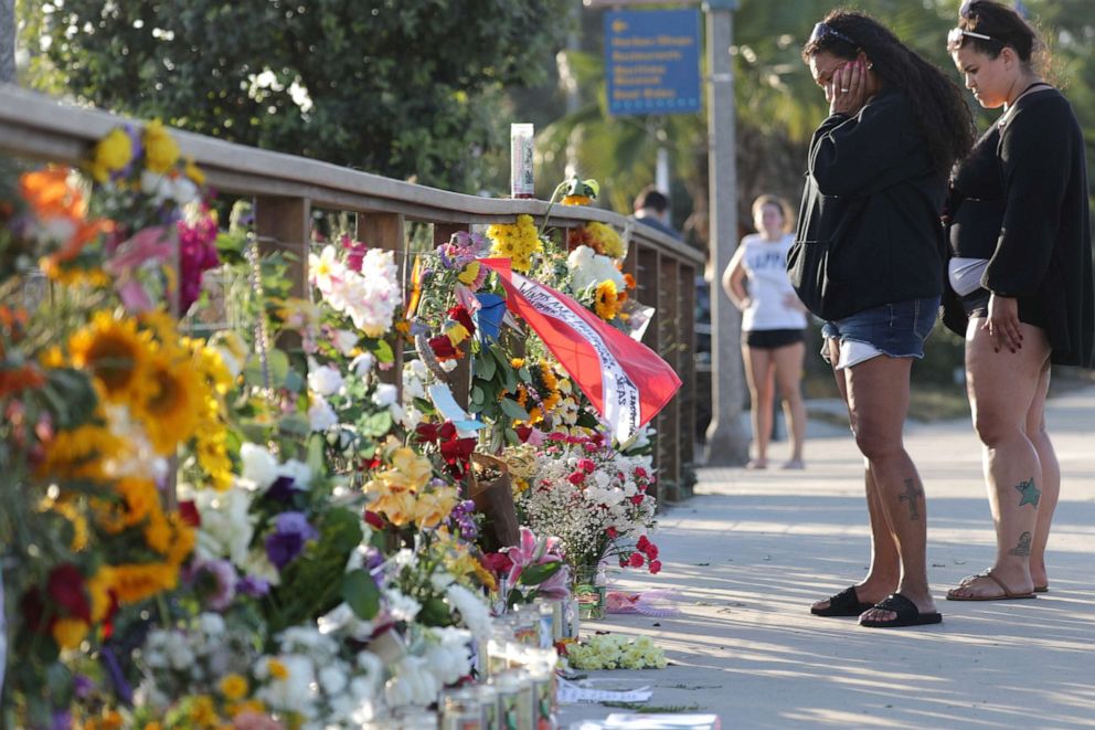 PHOTO: Women looks at flower tributes in Santa Barbara Harbor at a makeshift memorial for victims of the Conception boat fire, Sept. 3, 2019, in Santa Barbara, Calif. 