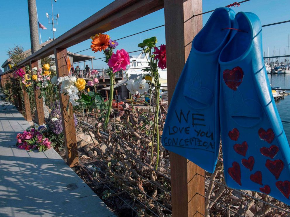 PHOTO: A pair of diving fins and flowers at a memorial wall near the Truth Aquatics moorings where the boat that burned and sank off the Santa Cruz islands, was based in Santa Barbara, Calif., on Sept. 2, 2019.
