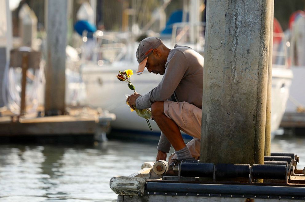 PHOTO: At Santa Barbara Harbor near Sea Landing dock, James Miranda kneels in prayer for the victims of the boat fire, Sept. 2, 2019. "I came here to bless the," Miranda says. "It's a very sad moment for California."