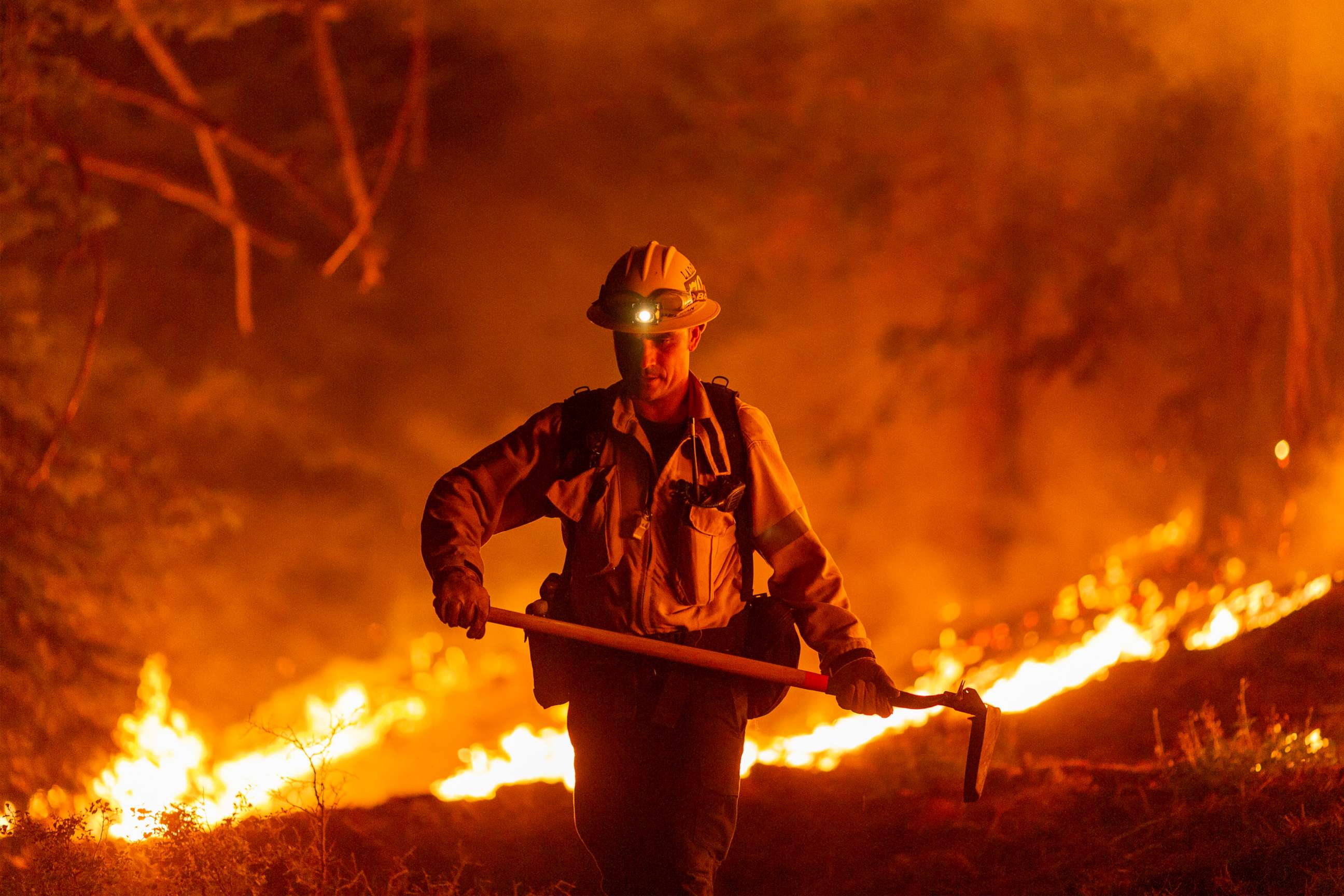 PHOTO: Los Angeles County firefighters, using only hand tools, keep fire from jumping a fire break at the Bobcat Fire in the Angeles National Forest on Sept. 11, 2020, north of Monrovia, Calif.