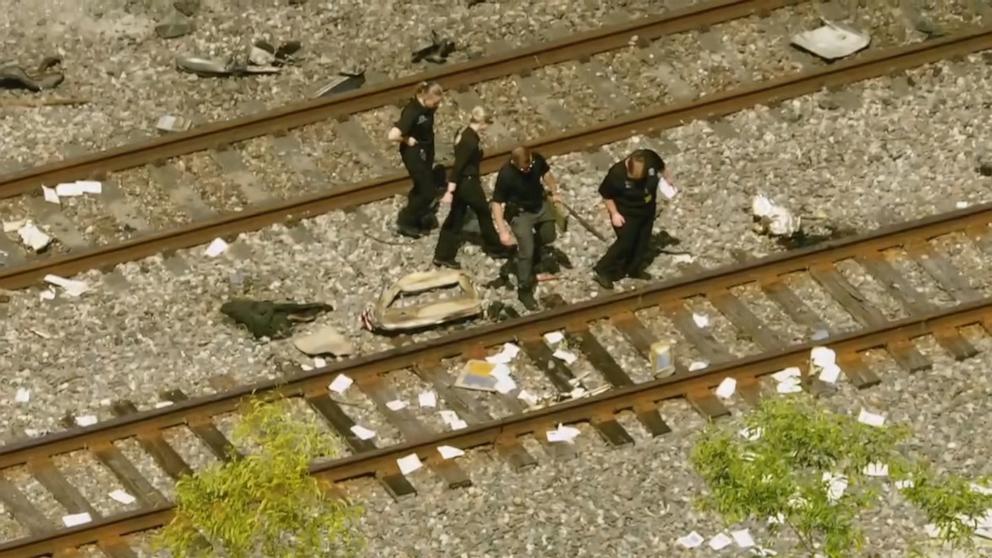 PHOTO: Police officers look at wreckage from a small plane crash in Boca Raton, Fla., Apr. 11, 2025.