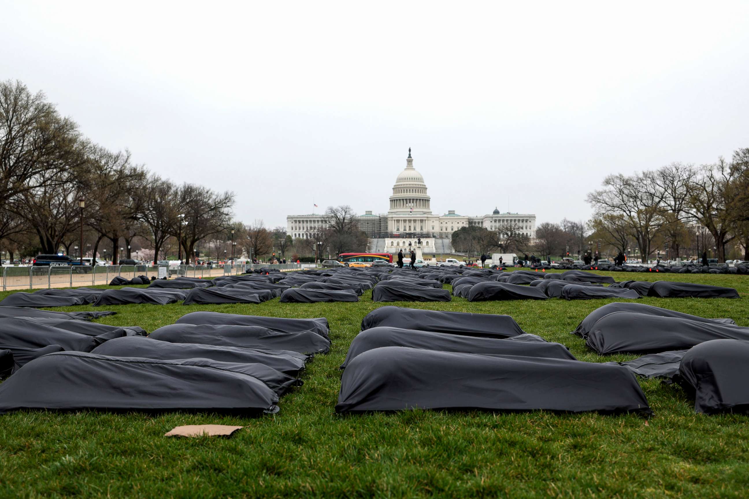 PHOTO: Body bags are assembled on the National Mall by gun control activist group March For Our Lives in Washington, March 24, 2022. 