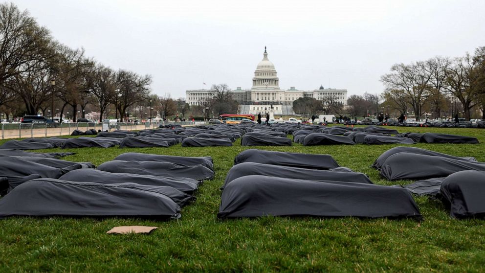 PHOTO: Body bags are assembled on the National Mall by gun control activist group March For Our Lives in Washington, March 24, 2022. 