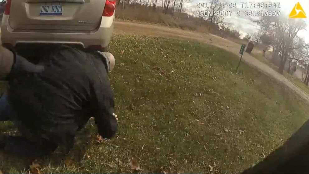 PHOTO: An Eaton County Sheriff detective is seen crawling to safety after being struck by his own vehicle during the incident.