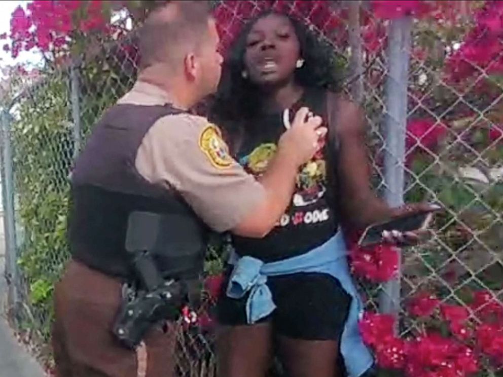 PHOTO: Alejandro Giraldo, a Miami-Dade police officer, arrests Dyma Loving.