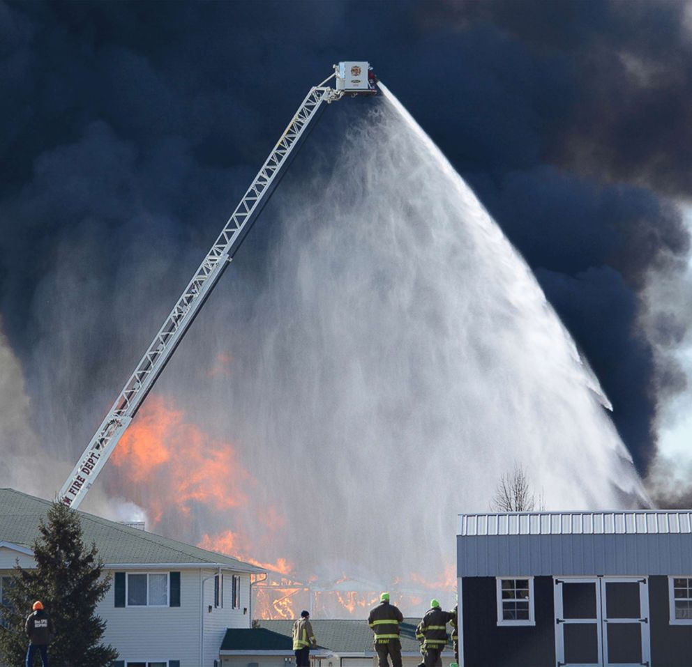 PHOTO: More than 100 firefighters from 20 area fire departments are on hand, March 15, 2018, for the controlled destruction of building 109 at the Village Glen apartment complex in Beaver Dam, Wis. 