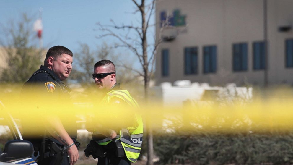 Police guard a road outside a FedEx facility following an explosion, March 20, 2018, in Schertz, Texas. A package exploded while being transported on a conveyor shortly after midnight this morning causing minor injuries to one person.