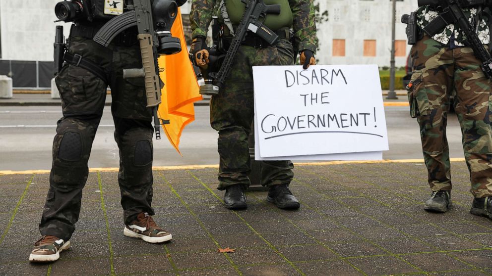 PHOTO: An armed group, who identify as "Liberty Boys" and the anti-government group "Boogaloo Bois" protest outside the Oregon State Capitol, as they advocate for less government control, in Salem, Oregon, U.S., Jan. 17, 2021.