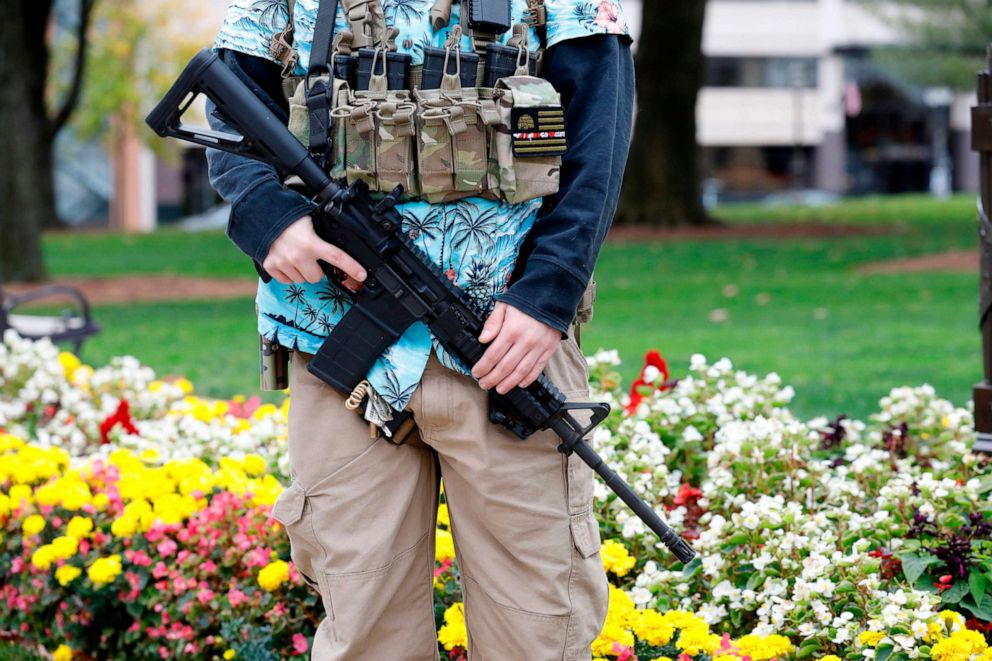 PHOTO: A group tied to the Boogaloo Bois holds a rally as they carry firearms at the Michigan State Capitol in Lansing, Mich., Oct. 17, 2020.