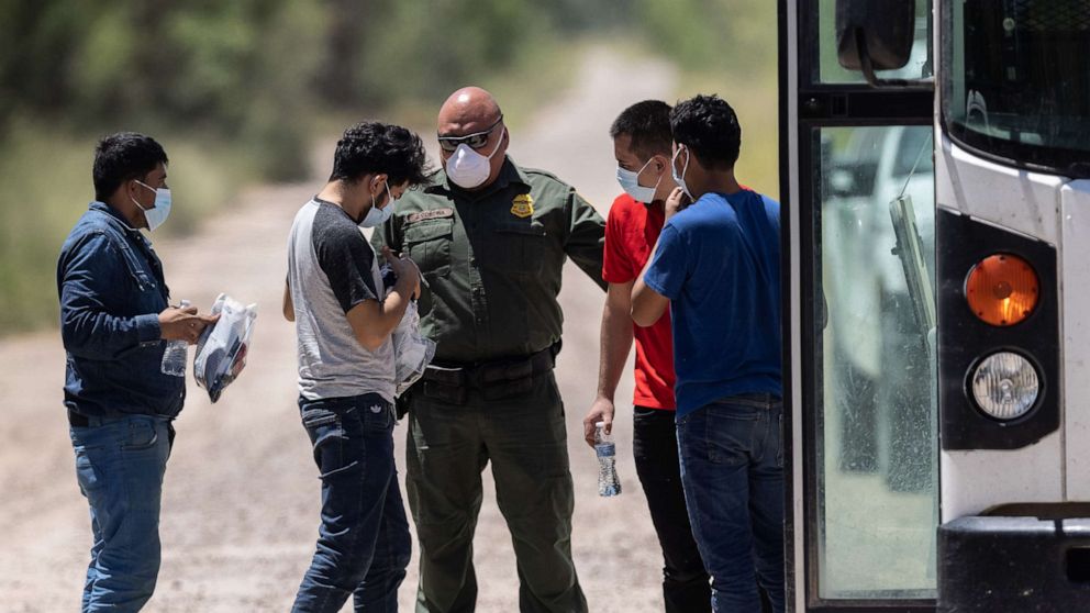 PHOTO: A U.S. Border Patrol agent instructs unaccompanied teenagers as they prepare to board transport to a processing center after crossing the U.S.-Mexico border on Aug. 13, 2021, in La Joya, Texas.