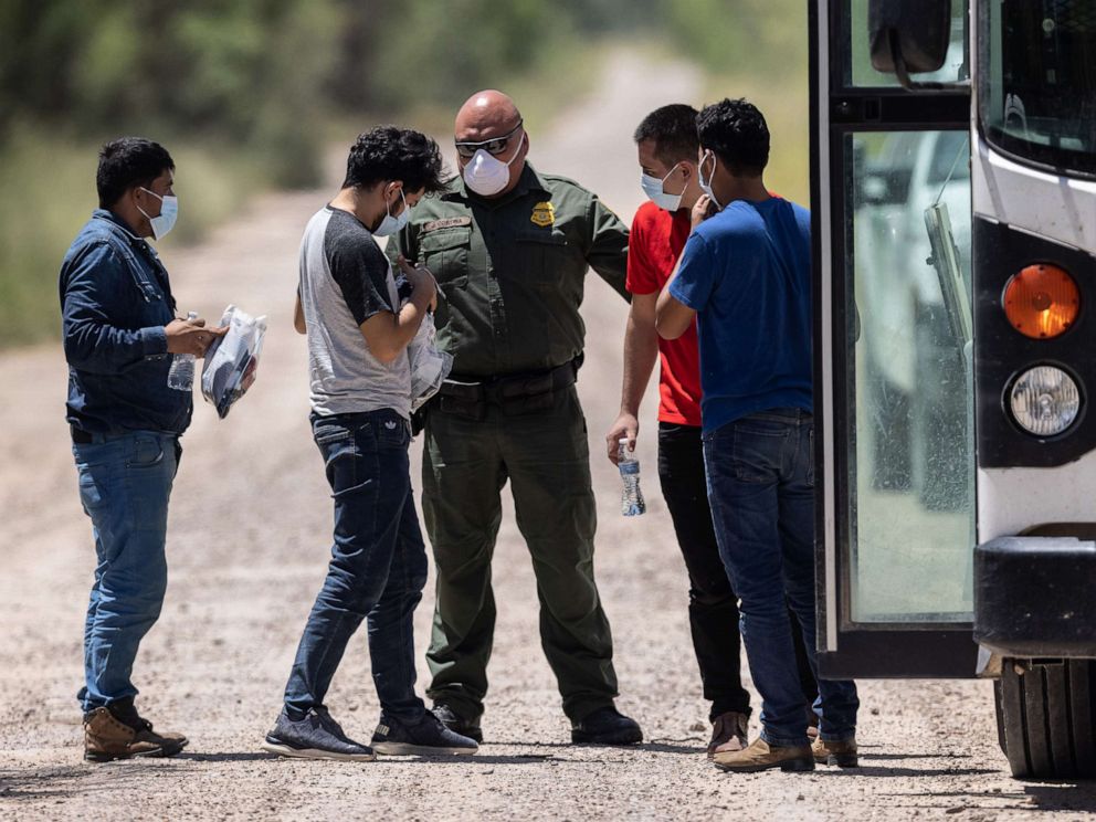 PHOTO: A U.S. Border Patrol agent instructs unaccompanied teenagers as they prepare to board transport to a processing center after crossing the U.S.-Mexico border on Aug. 13, 2021, in La Joya, Texas.