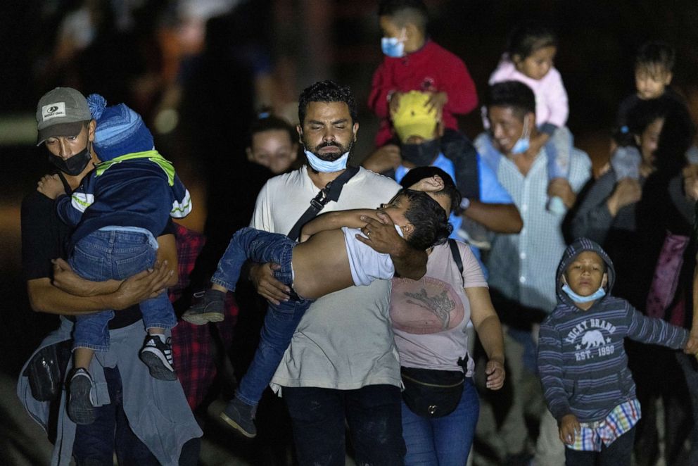 PHOTO: Immigrants walk towards a U.S. Border Patrol checkpoint after they crossed the Rio Grande from Mexico on Aug. 14, 2021, in Roma, Texas.