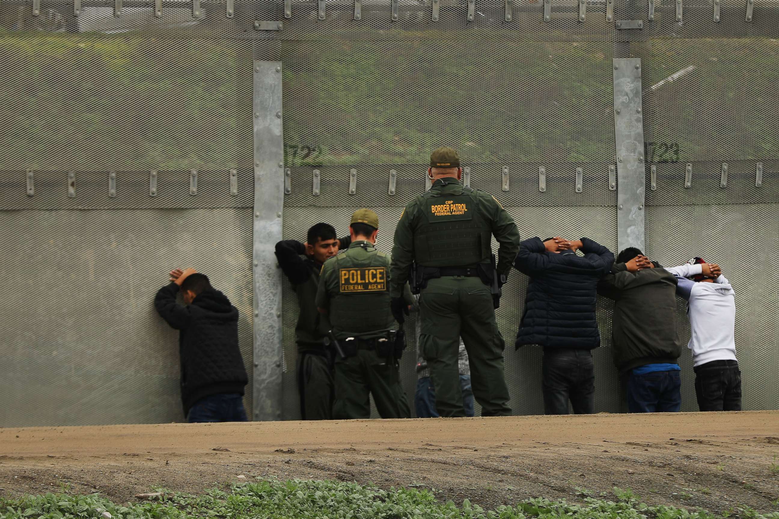 PHOTO: Men surrender to United States Border Patrol agents after jumping a fence in an attempt to get into America, Jan. 17, 2019, in Tijuana, Mexico. 