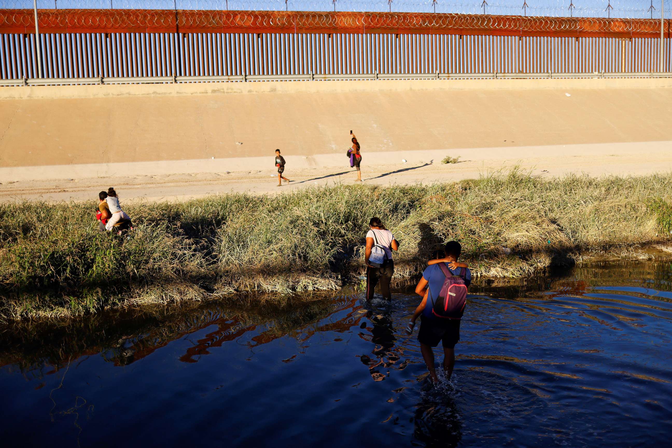 PHOTO: Asylum-seeking migrants from Venezuela cross the Rio Bravo river to turn themselves in to U.S. Border Patrol agents to request asylum in El Paso, Texas, as seen from Ciudad Juarez, Mexico, Oct. 12, 2022.