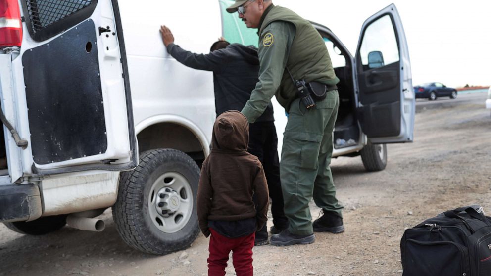PHOTO: In this Feb. 1, 2019, file photo, a child watches as a U.S. Border Patrol agent searches a fellow Central American immigrant after they crossed the border from Mexico, in El Paso, Texas.