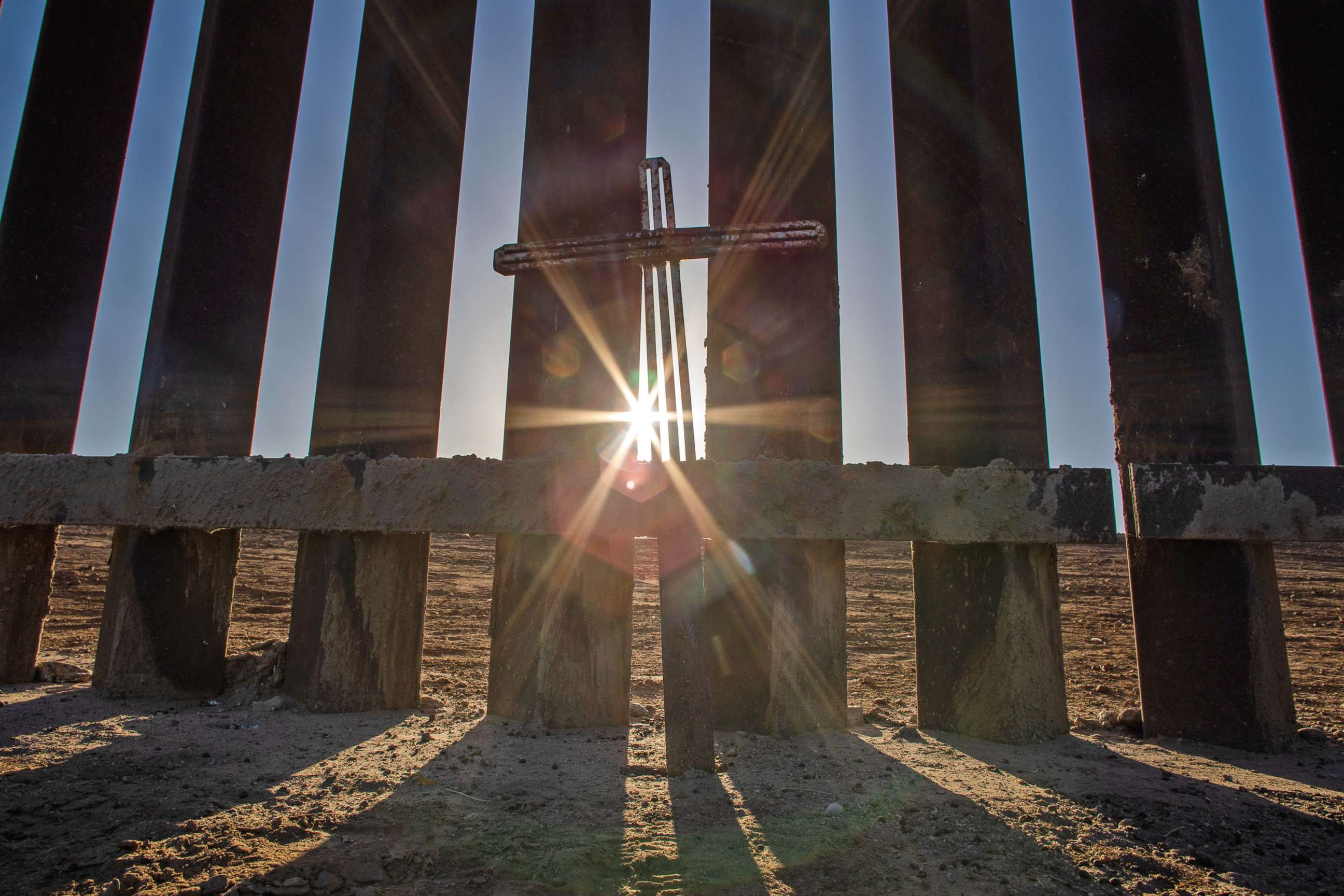 PHOTO: A metal cross stands at the wall on the US-Mexico border on May 12, 2021 in Yuma, Arizona.
