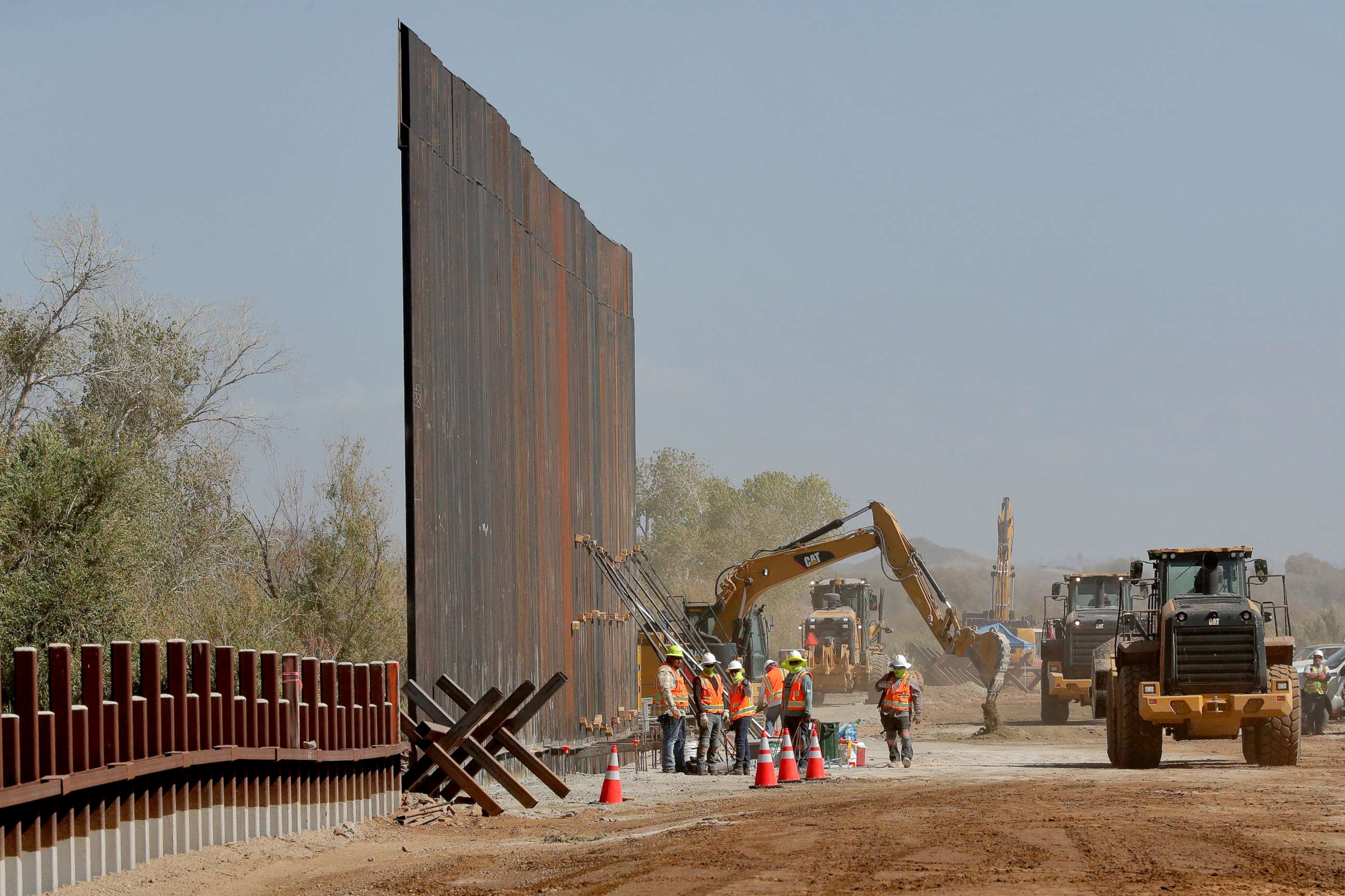 PHOTO: In this Sept. 10, 2019 file photo government contractors erect a section of Pentagon-funded border wall along the Colorado River in Yuma, Ariz.
