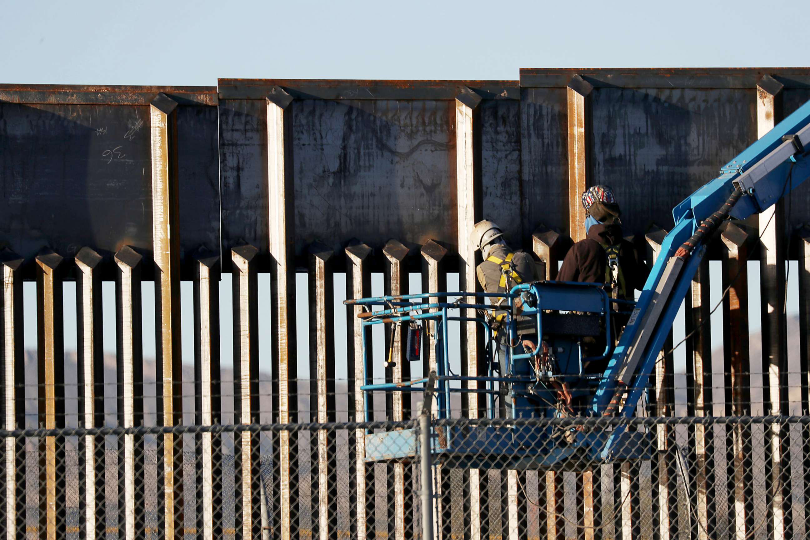 PHOTO: People work on the U.S./Mexican border wall, Feb. 12, 2019, in El Paso, Texas.