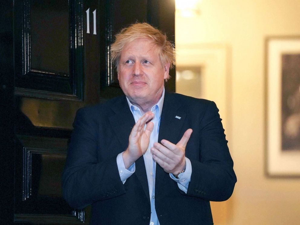 PHOTO: Britain's Prime Minister Boris Johnson claps outside 11 Downing Street to salute local heroes during Thursday's nationwide Clap for Carers NHS initiative to applaud workers fighting the coronavirus pandemic, in London, Thursday, April 2, 2020. 