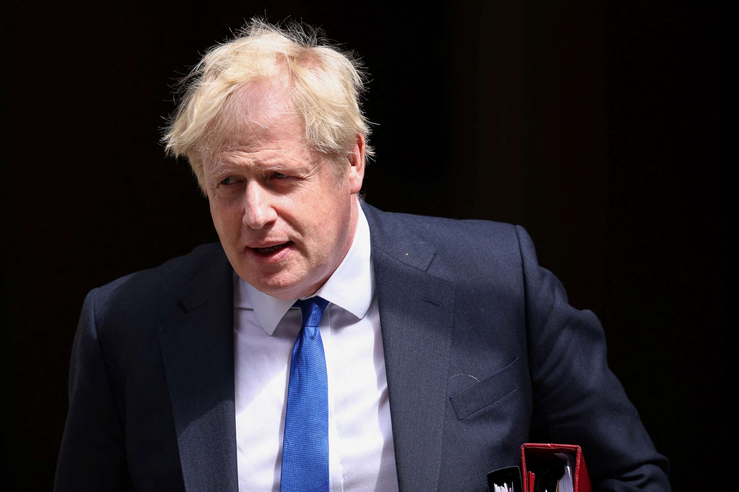 PHOTO: British Prime Minister Boris Johnson walks at Downing Street in London, July 6, 2022.