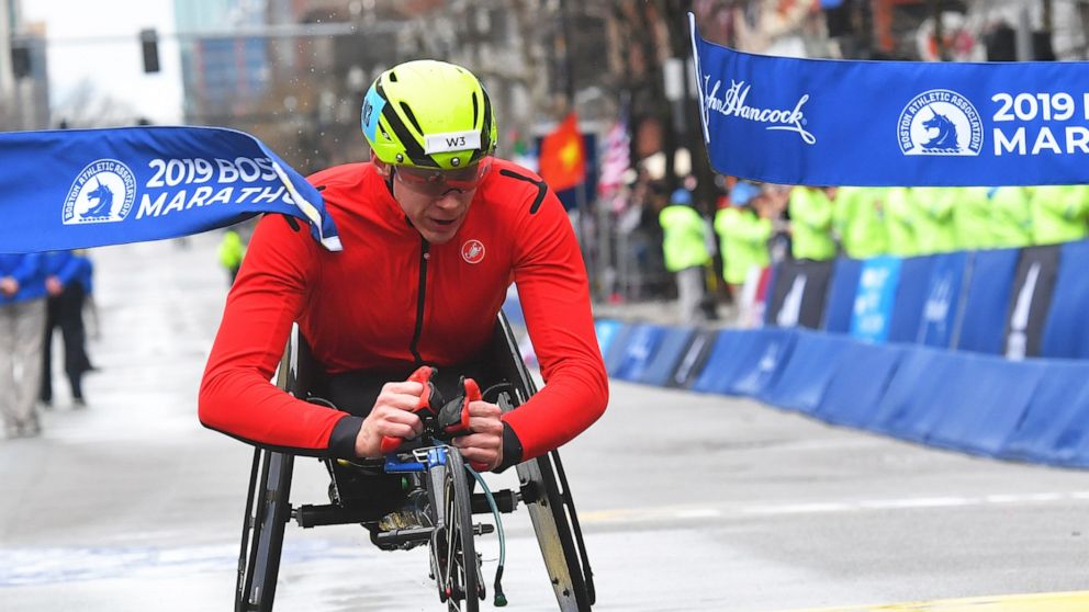 Daniel Romanchuk crosses the finish line first in the wheelchair division during the 123rd running of the Boston Marathon, April 15, 2019.
