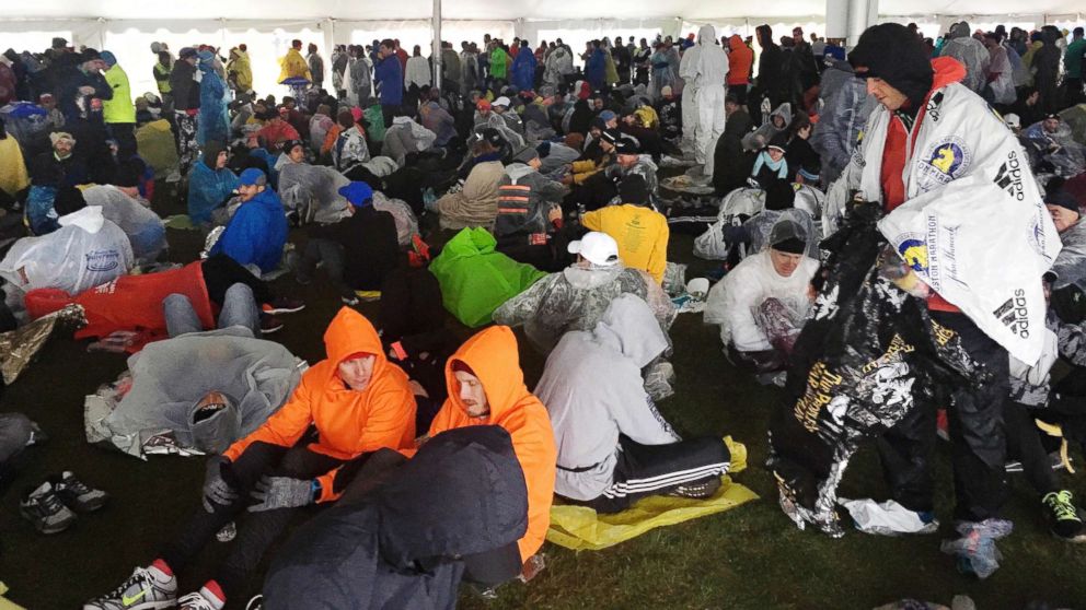 PHOTO: Runners wait under a tent at the athlete's village for the start of the the 122nd Boston Marathon, April 16, 2018, in Hopkinton, Mass.