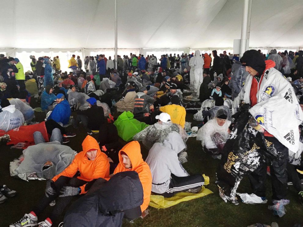 PHOTO: Runners wait under a tent at the athletes village for the start of the the 122nd Boston Marathon, April 16, 2018, in Hopkinton, Mass.