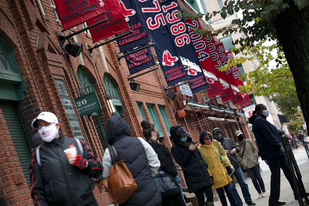 PHOTO: People wait in line for early voting to open at Fenway Park, Saturday, Oct. 17, 2020, in Boston.