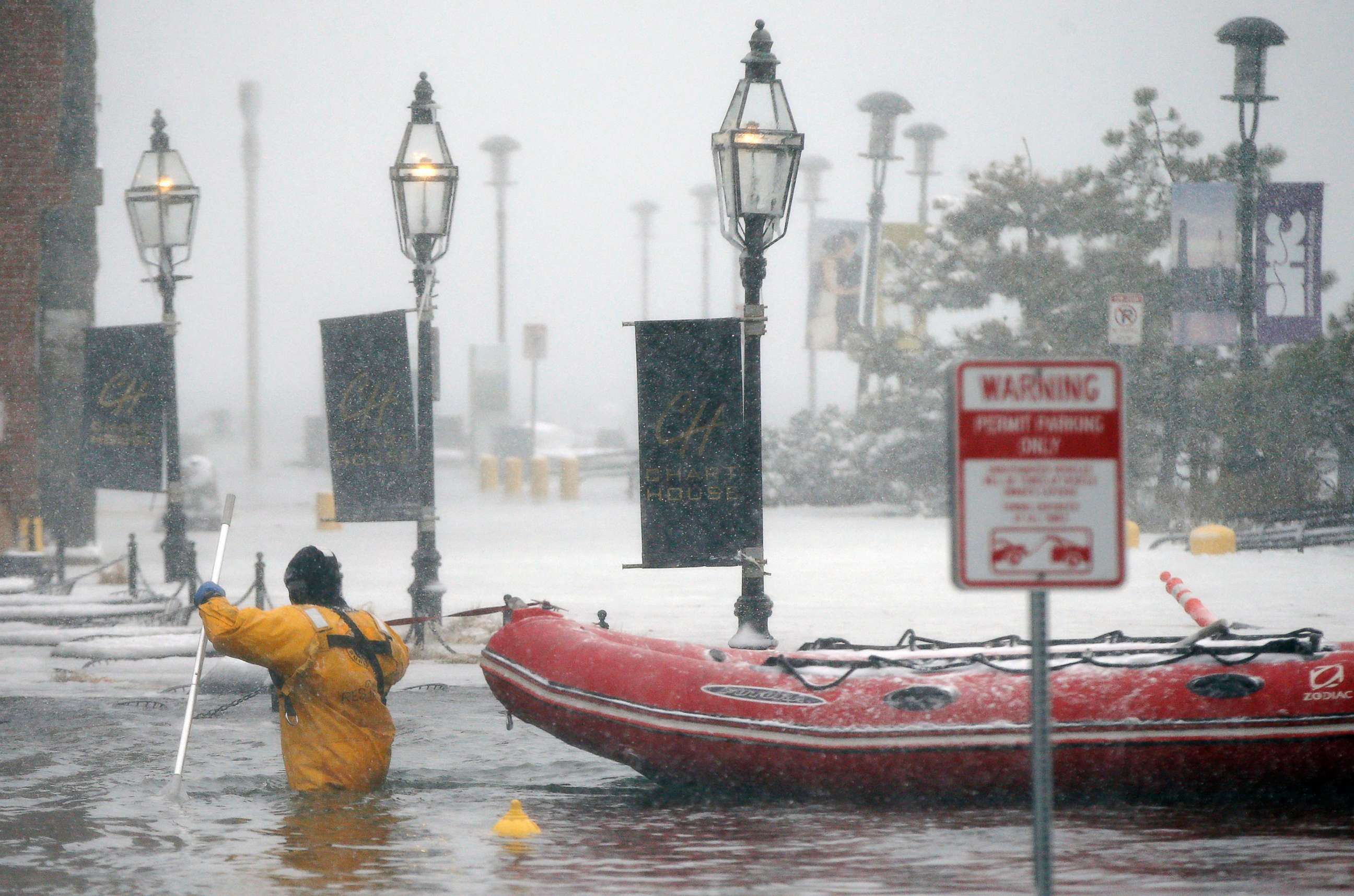 PHOTO: A firefighter wades through flood waters from Boston Harbor on Long Wharf in Boston, Jan. 4, 2018. 