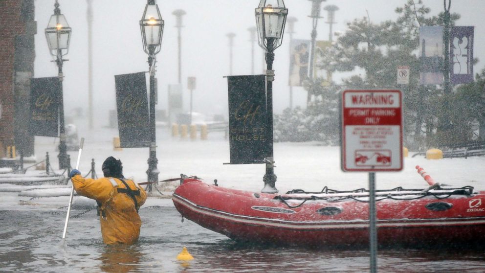 PHOTO: A firefighter wades through flood waters from Boston Harbor on Long Wharf in Boston, Jan. 4, 2018. 