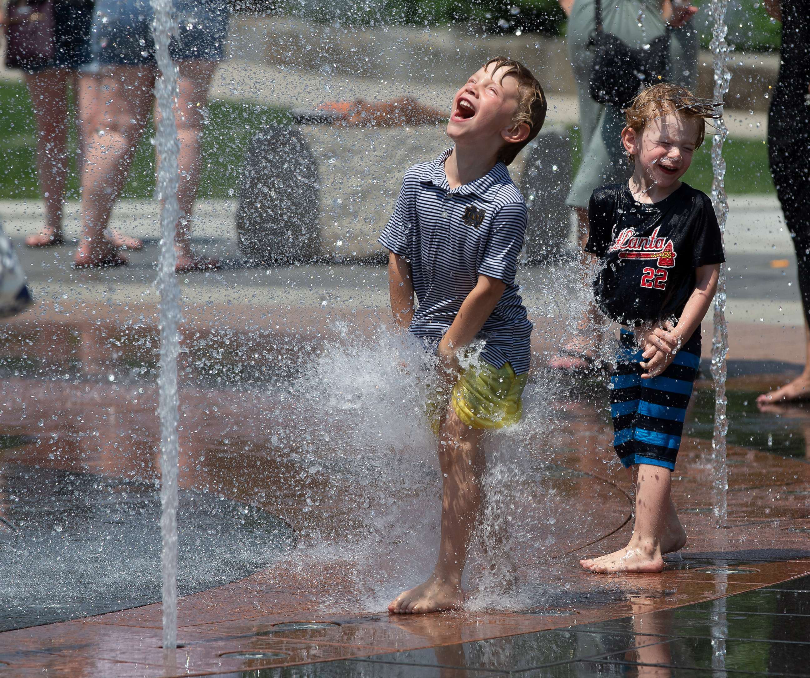 PHOTO: Children play in a water fountain on the Rose Fitzgerald Kennedy Greenway in Boston, on a hot day, June 7, 2021.